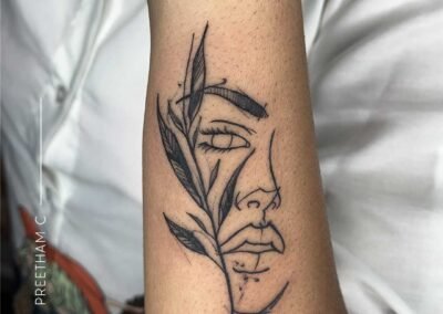 Face line wrist tattoo